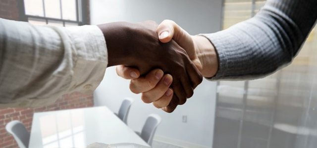 Image of two people shaking hands at an interview